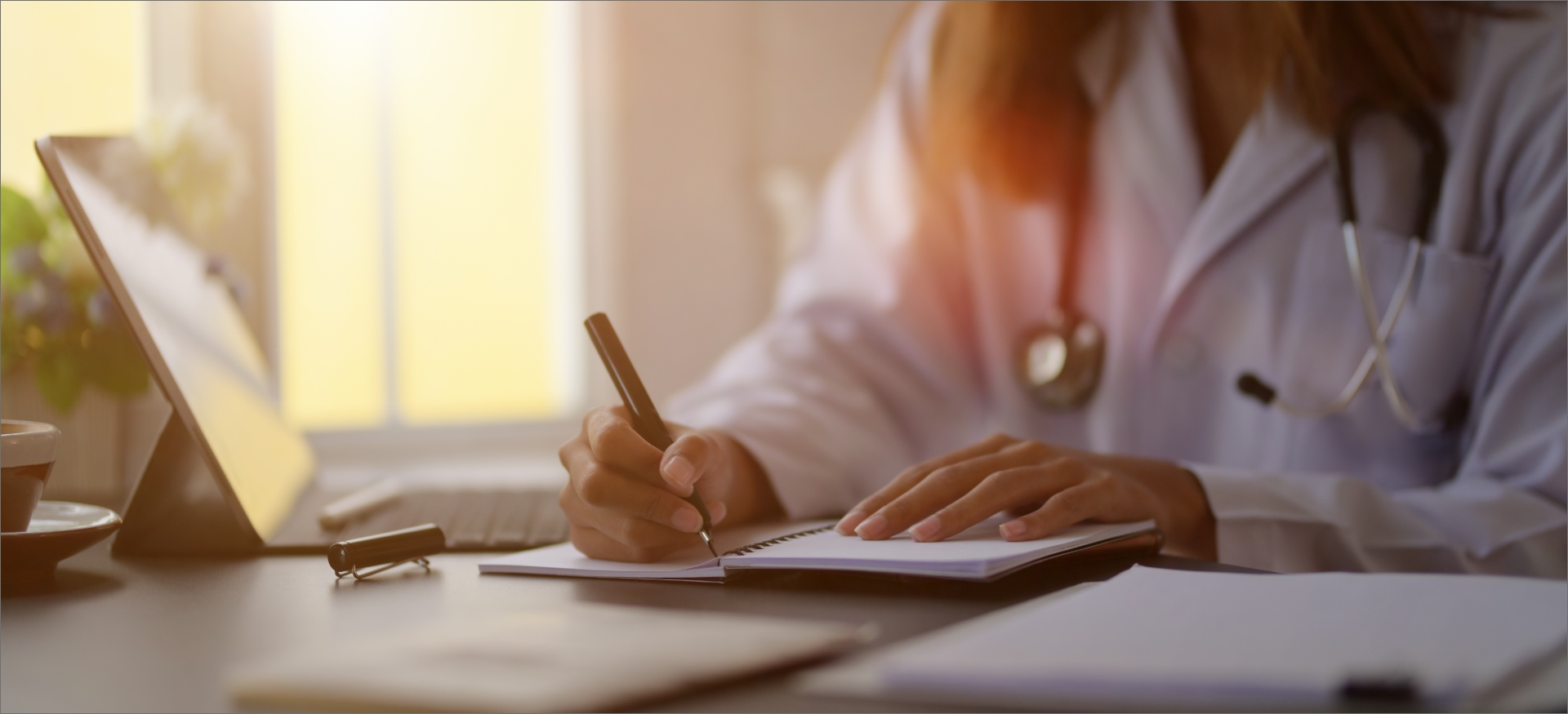 close-up-view-young-female-doctor-writing-medical-charts-with-tablet-office-room